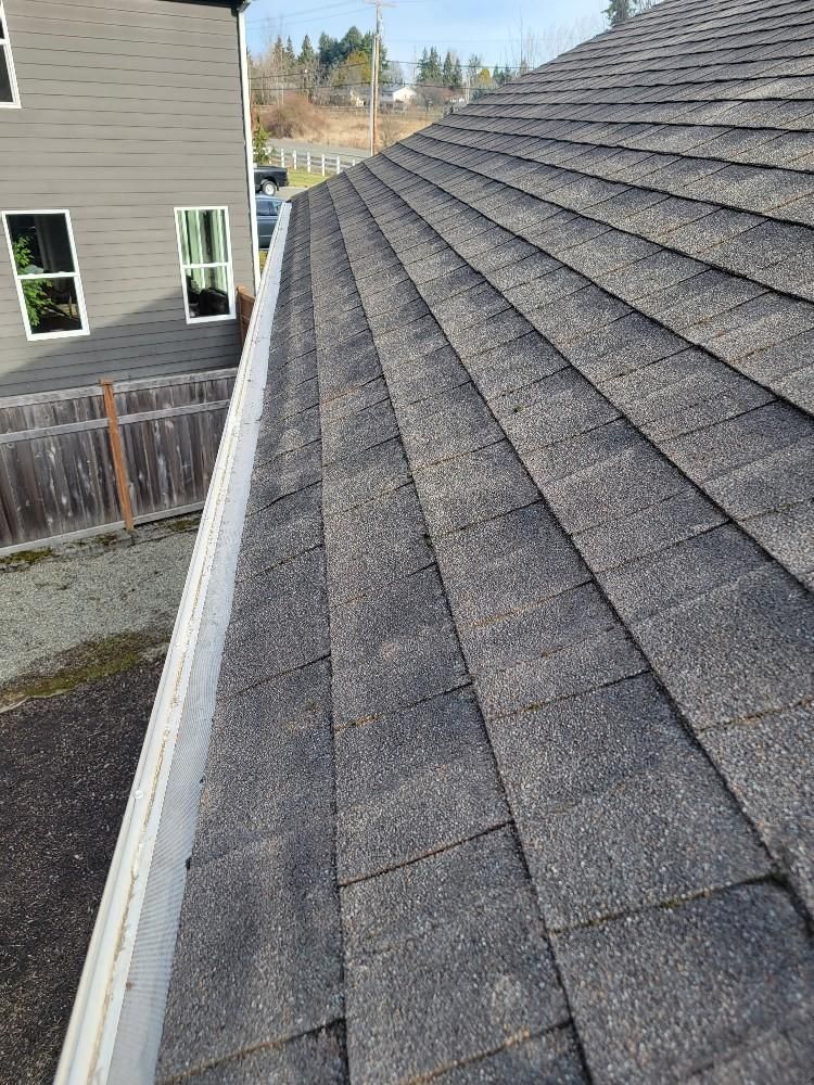 A close up of a gutter on the roof of a house.