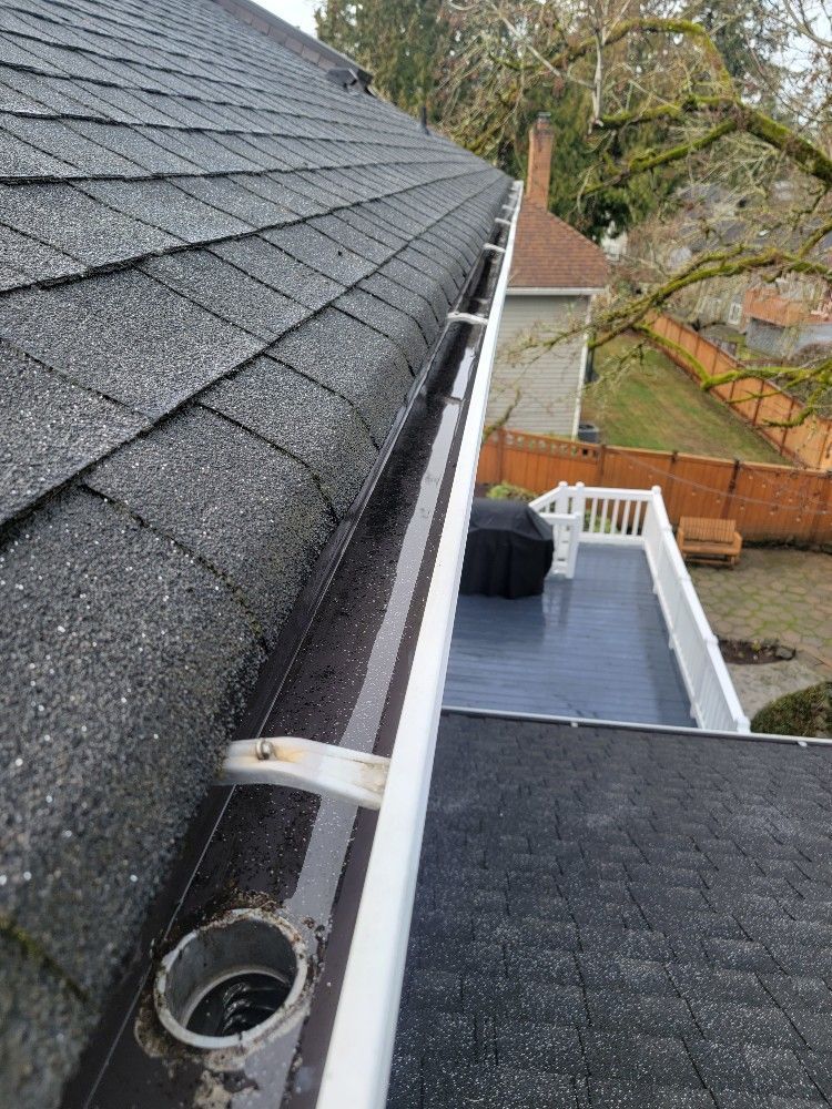 A close up of a gutter on a roof of a house.