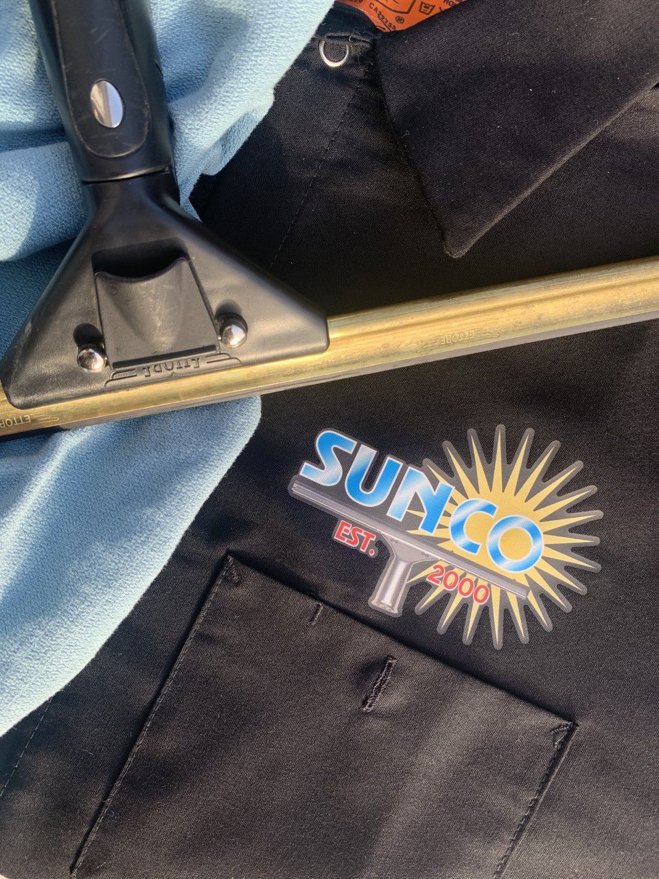 A black shirt with a sunco logo on it