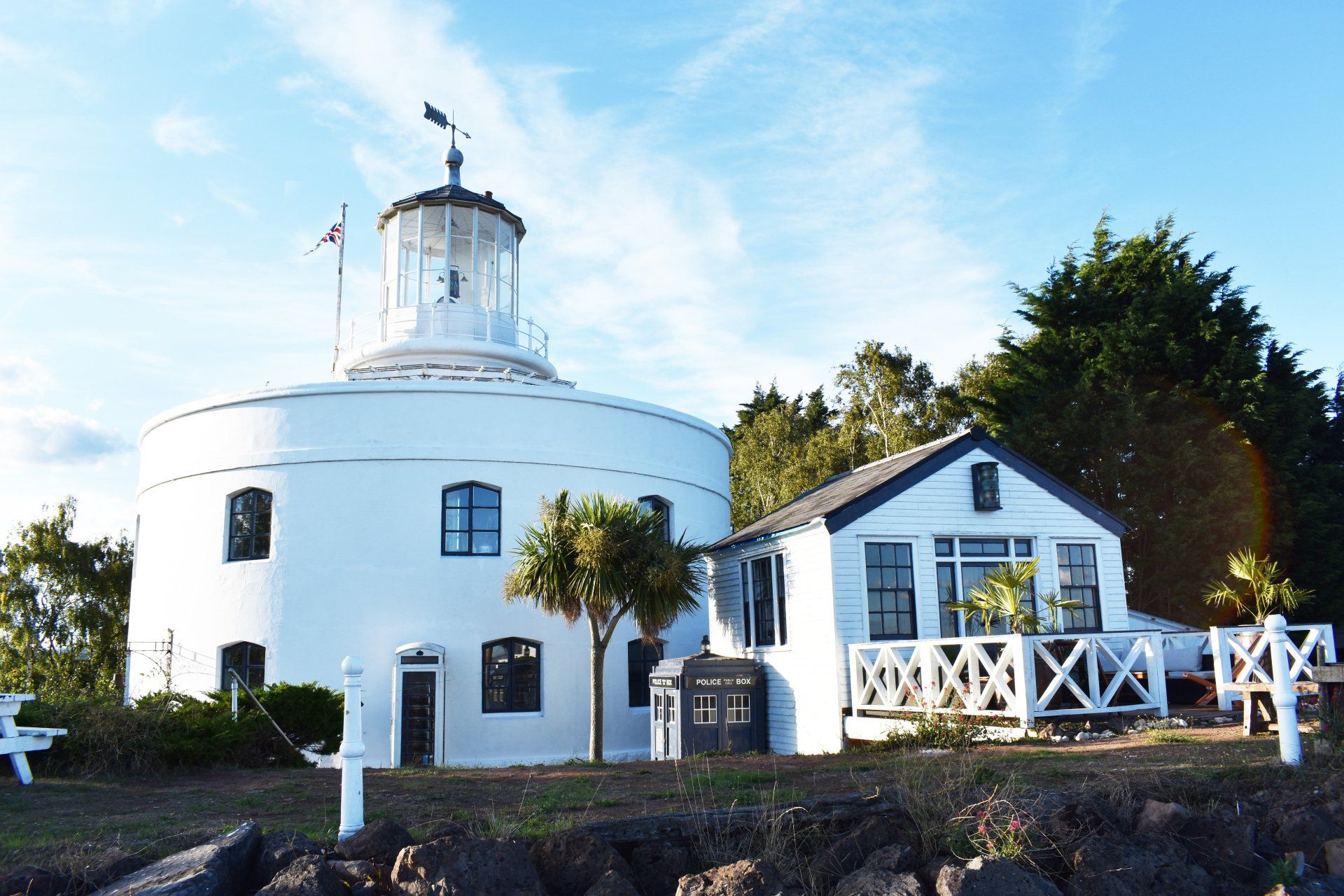 The outside of the 'Light-keepers Lodge' at the West Usk Lighthouse, including the lighthouse next to it.