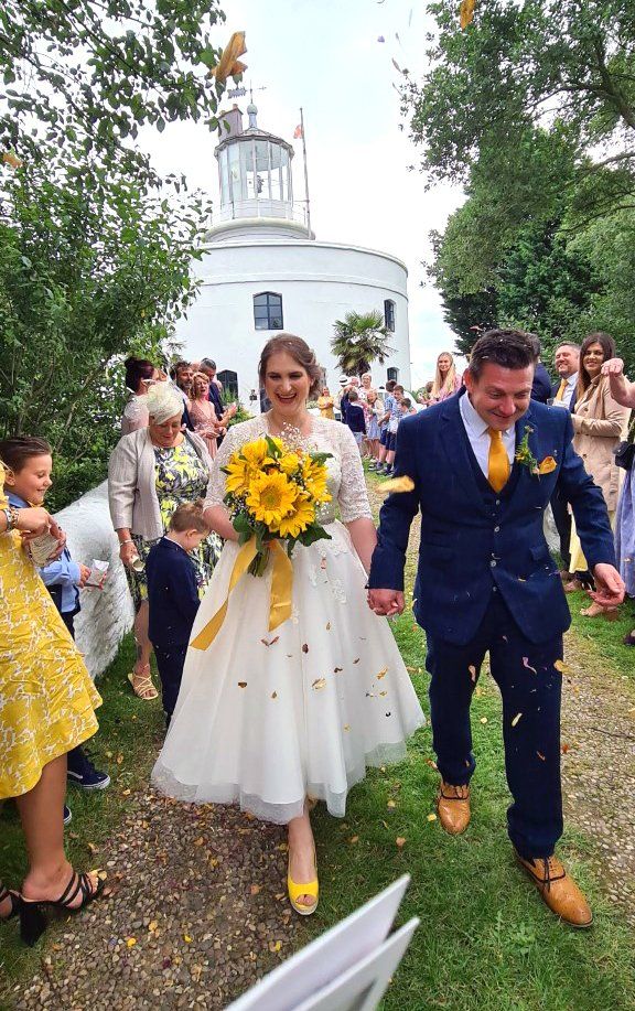 A wedding couple at the West Usk Lighthouse (woman and man).