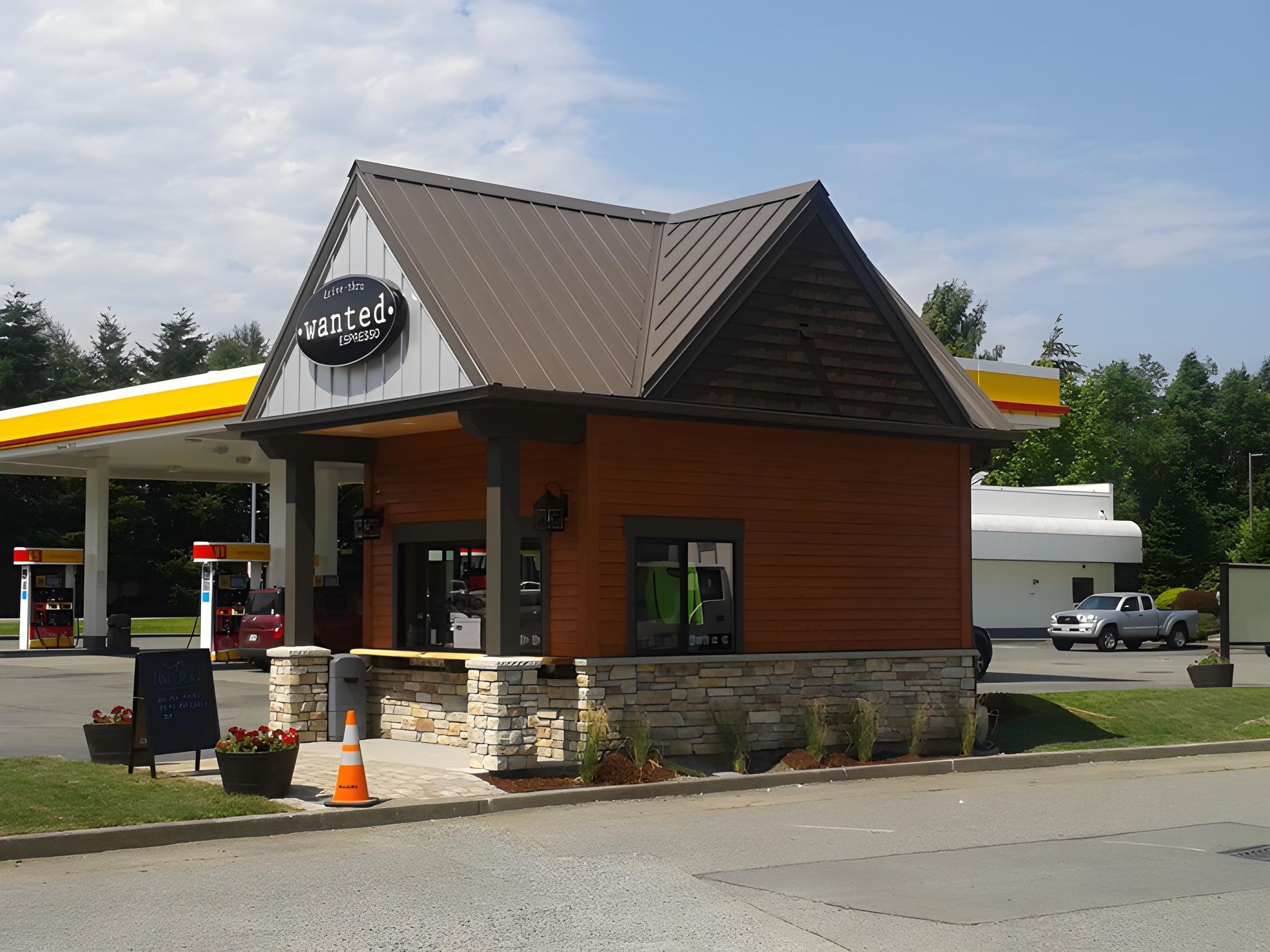 A tiny drive through coffee stand in Washington with a brown metal roof.