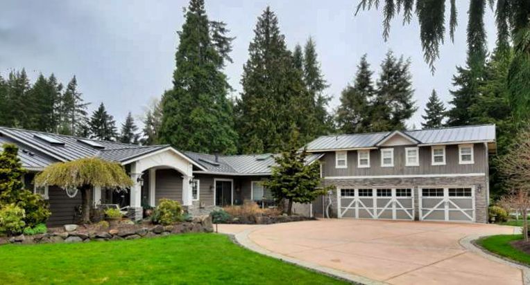 A single family home with attached three car garage in Washington has a metal roof.