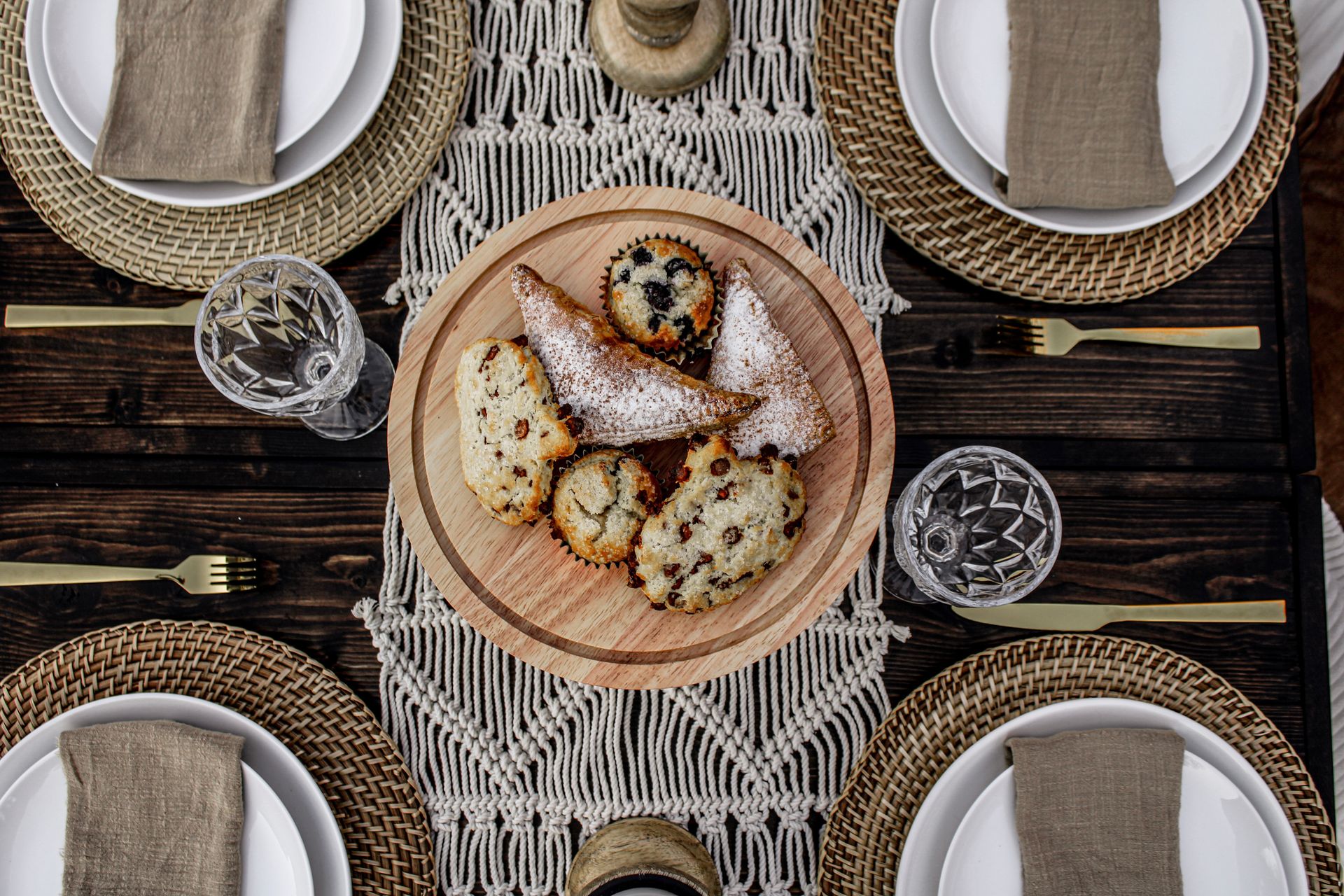 A wooden table with plates , utensils , and a plate of food on it.