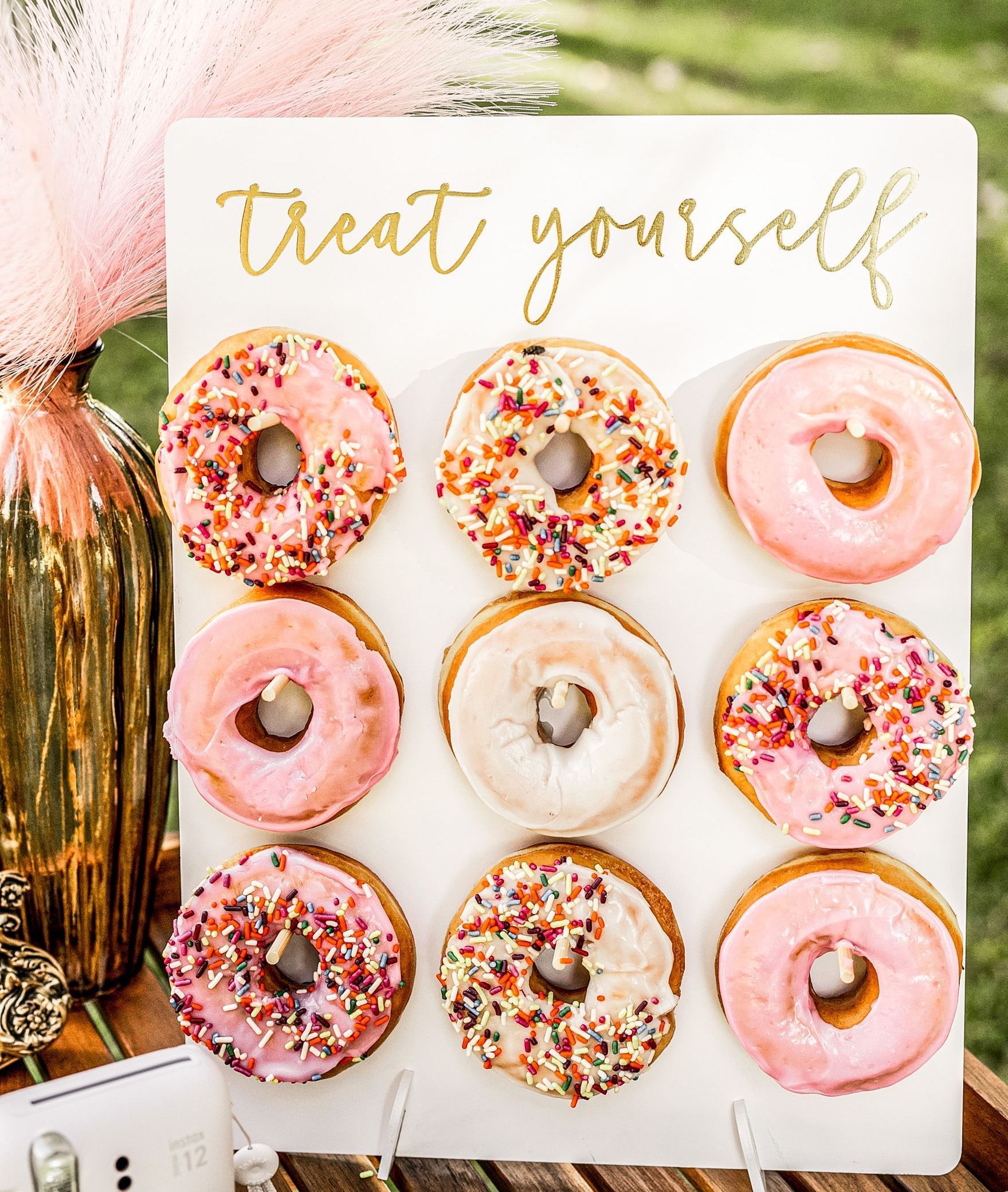 A donut wall with a sign that says treat yourself