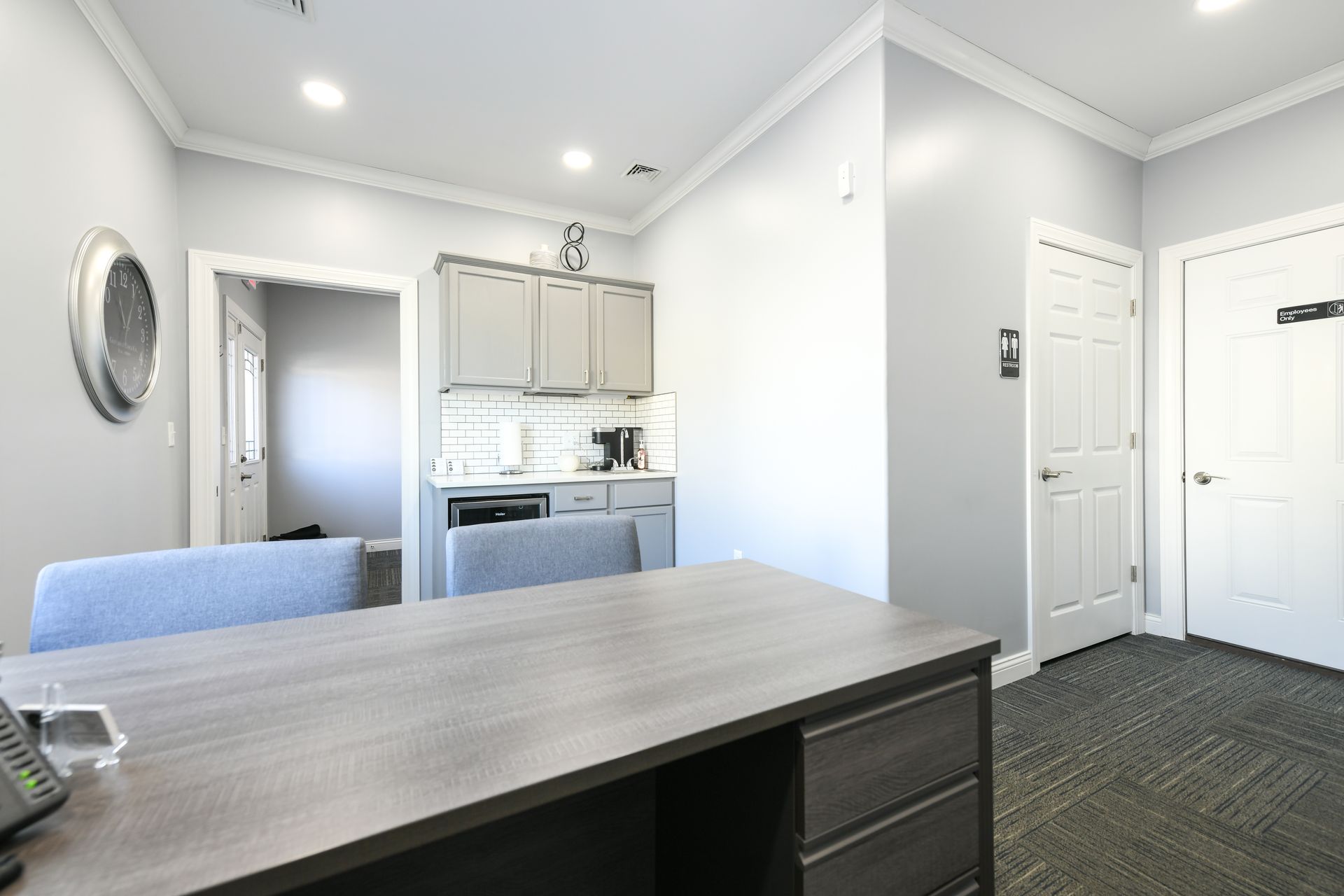 There is a desk and chair in the middle of the room.