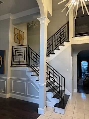 A staircase with a black railing in a house
