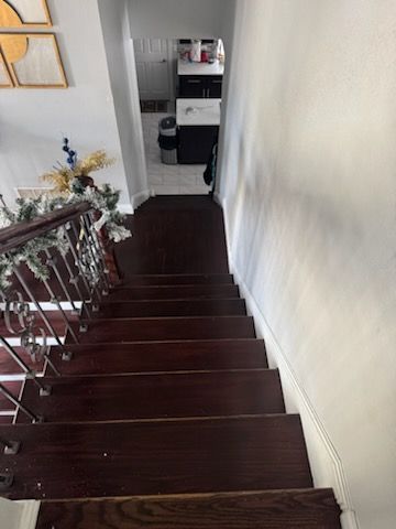 A wooden staircase leading up to the second floor of a house