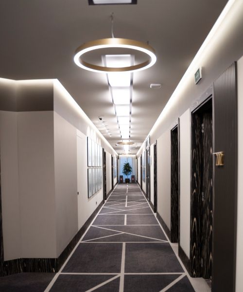 A long hallway with a circular light hanging from the ceiling