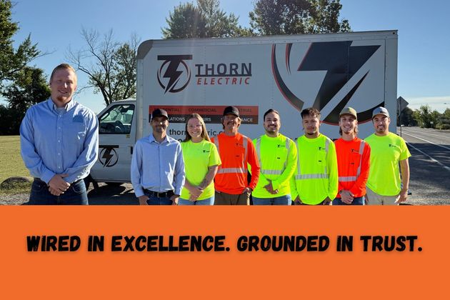 Thorn Electric team standing in front of their service van. They are wearing safety vests; tagline: 