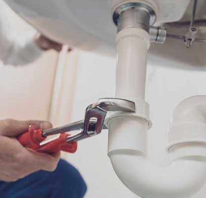 Plumber fixing a sink at home
