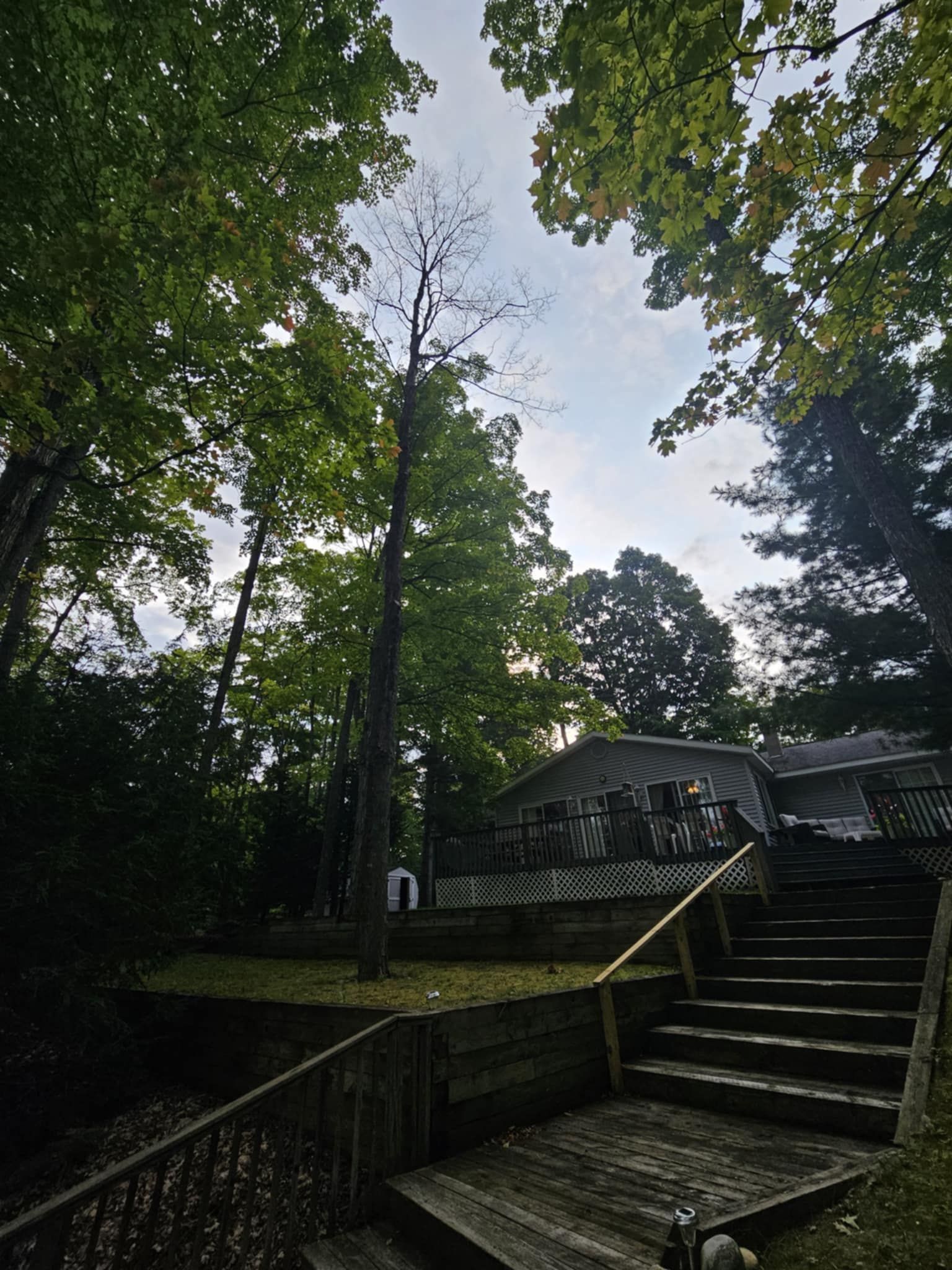 A house with a wooden deck and stairs leading up to it
