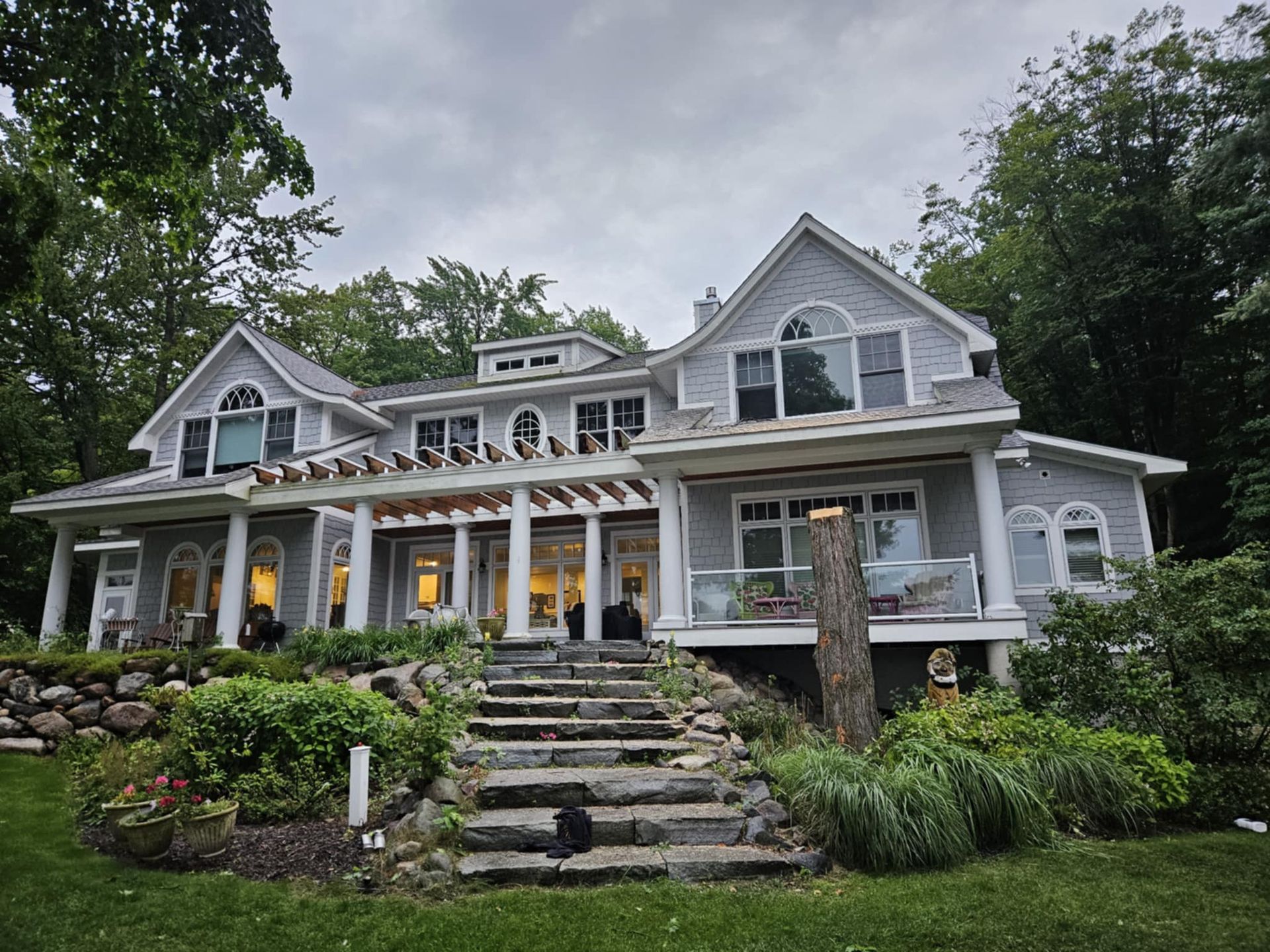 A large house with stairs leading up to it