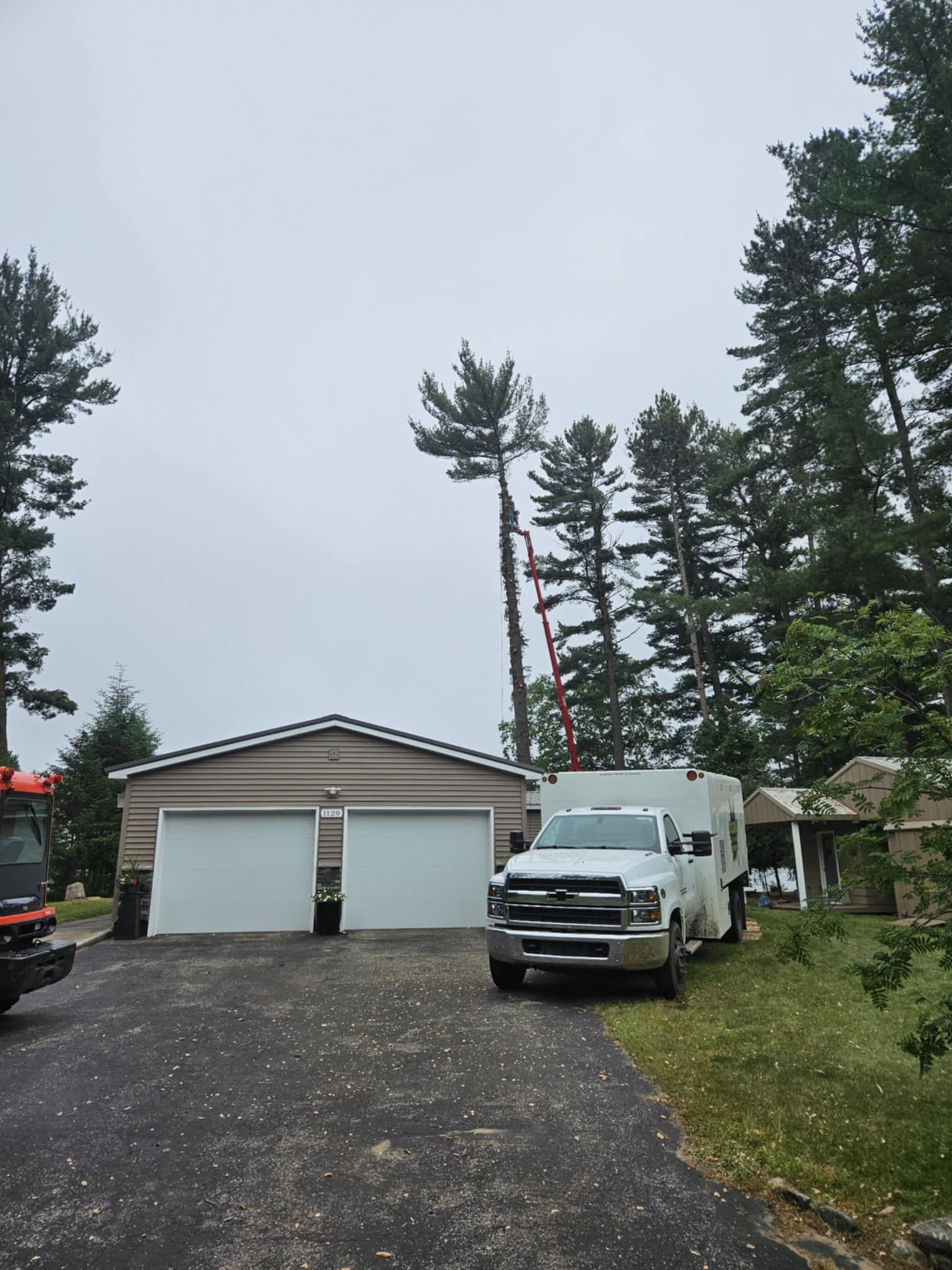 A white truck is parked in front of a garage.