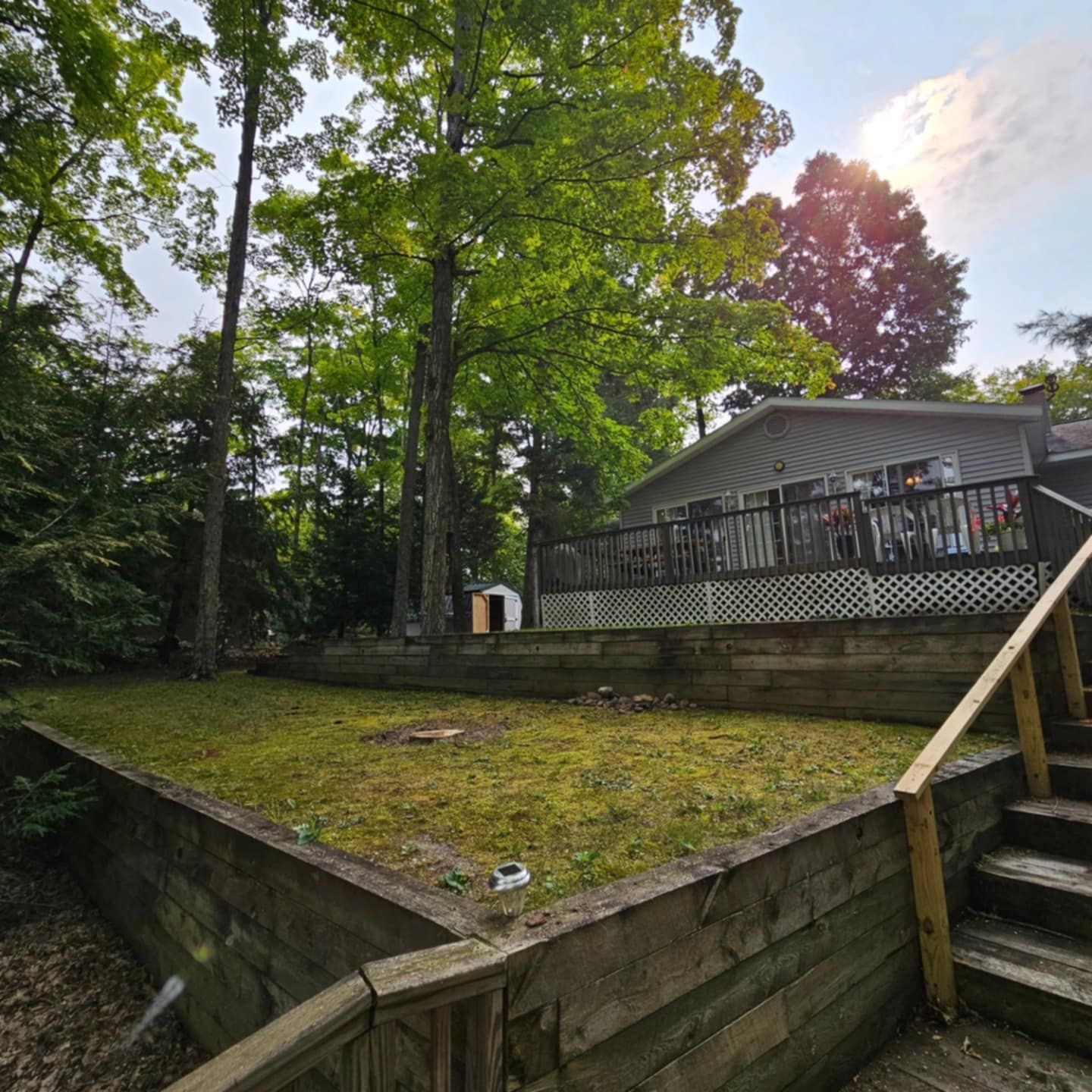 A house with a wooden deck and stairs leading up to it