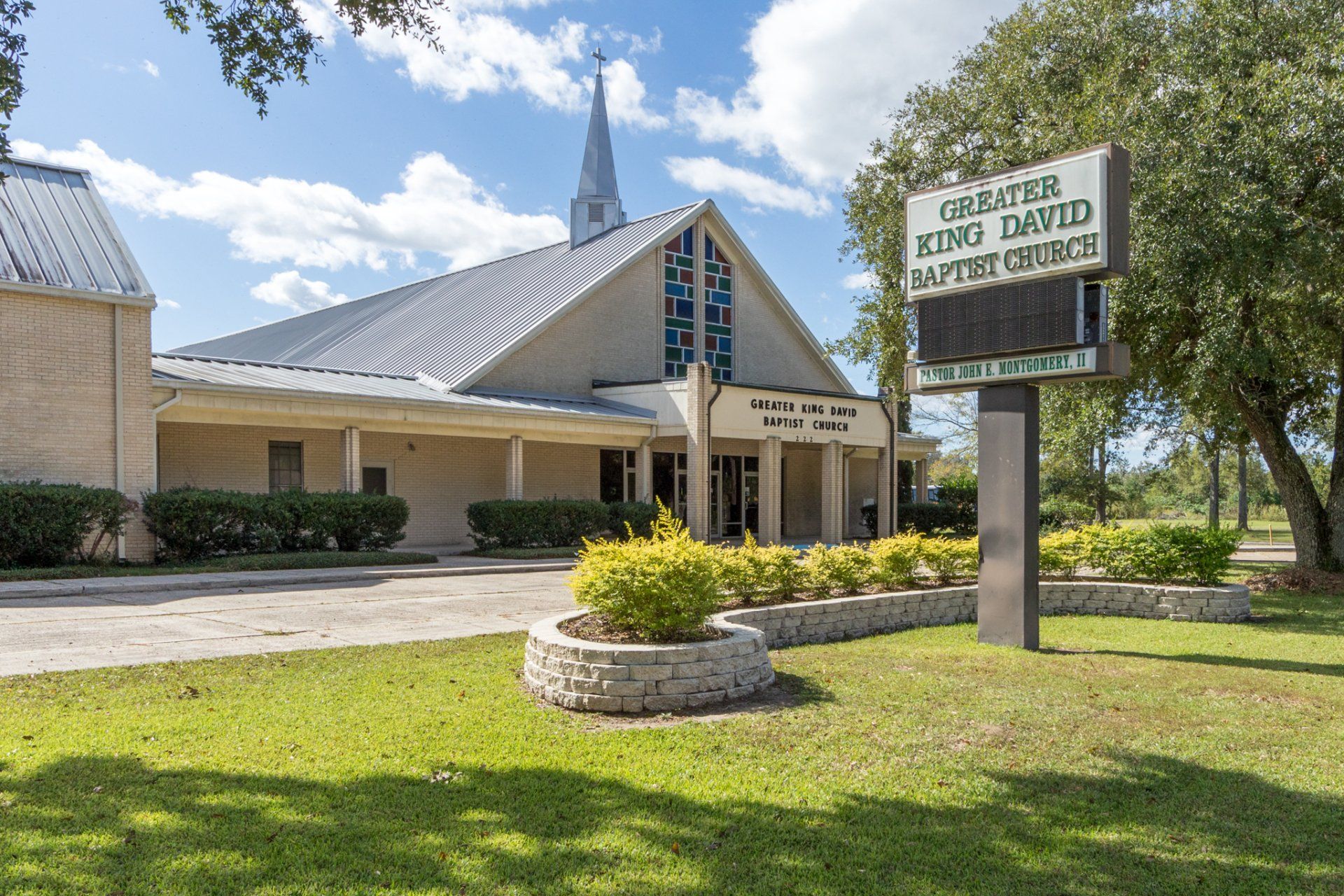 Greater King David Baptist Church building with steeple and sign.