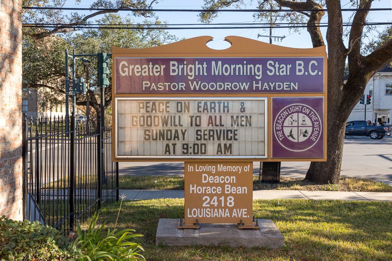 Sign for Greater Bright Morning Star B.C. church, listing the pastor, service time, and address.