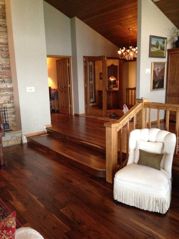 A living room with hardwood floors and stairs