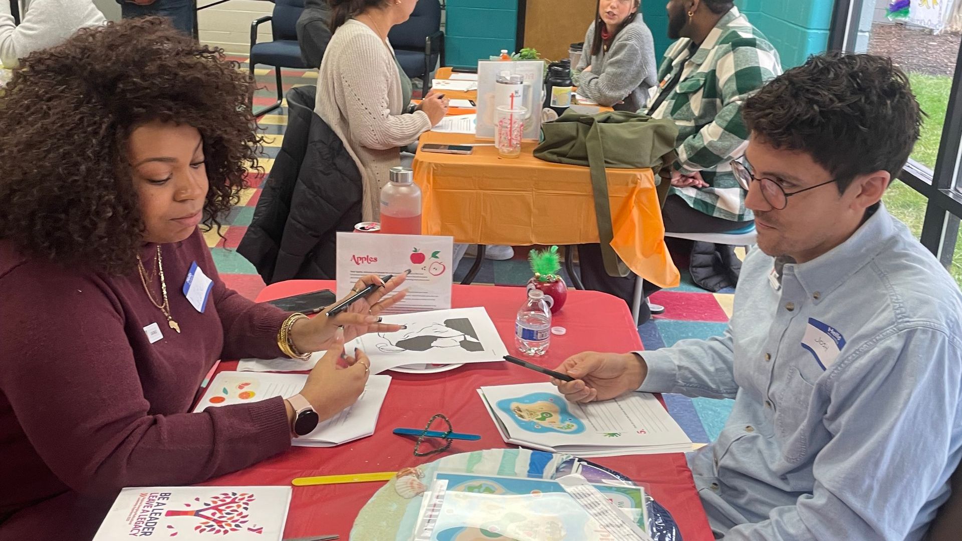 Alternatives to DEI Training: A man and a woman are sitting at a table painting.