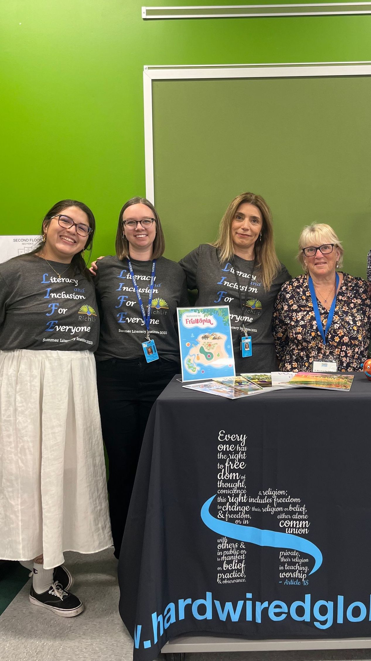 Alternatives to DEI Training: A group of women are posing for a picture in front of a table.