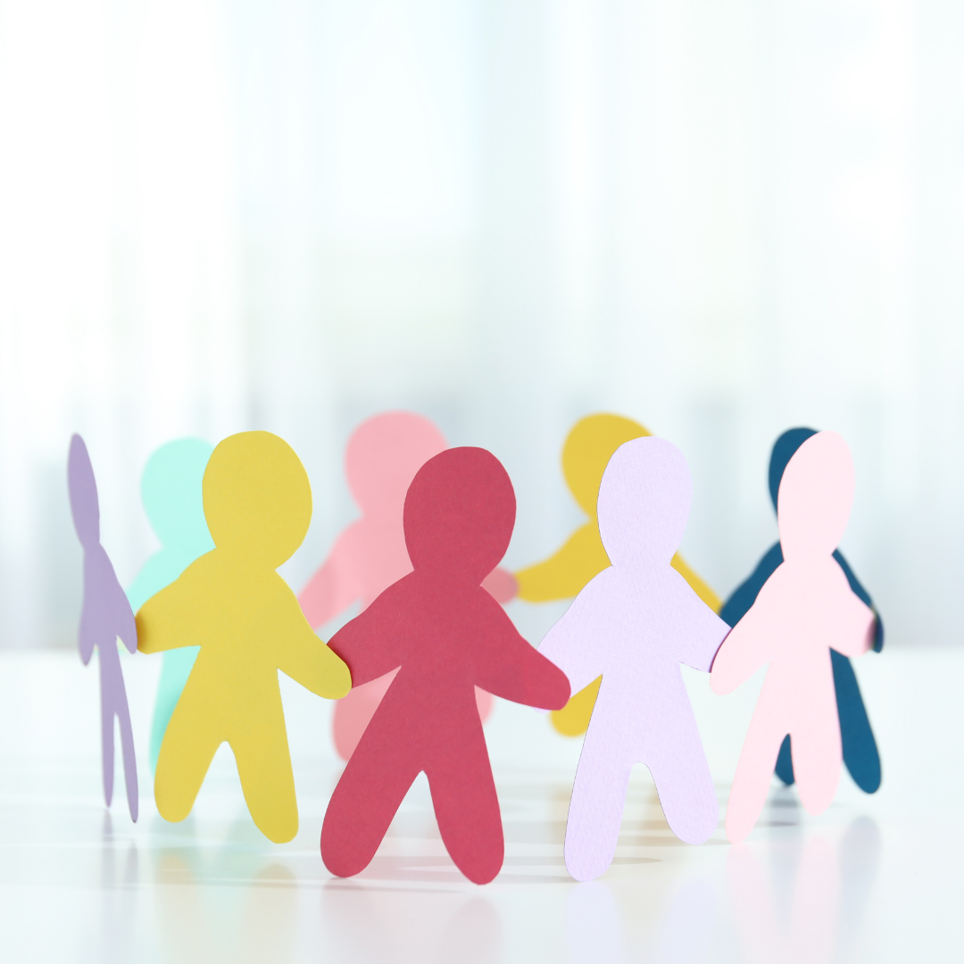 Paper cutouts of people connected.  