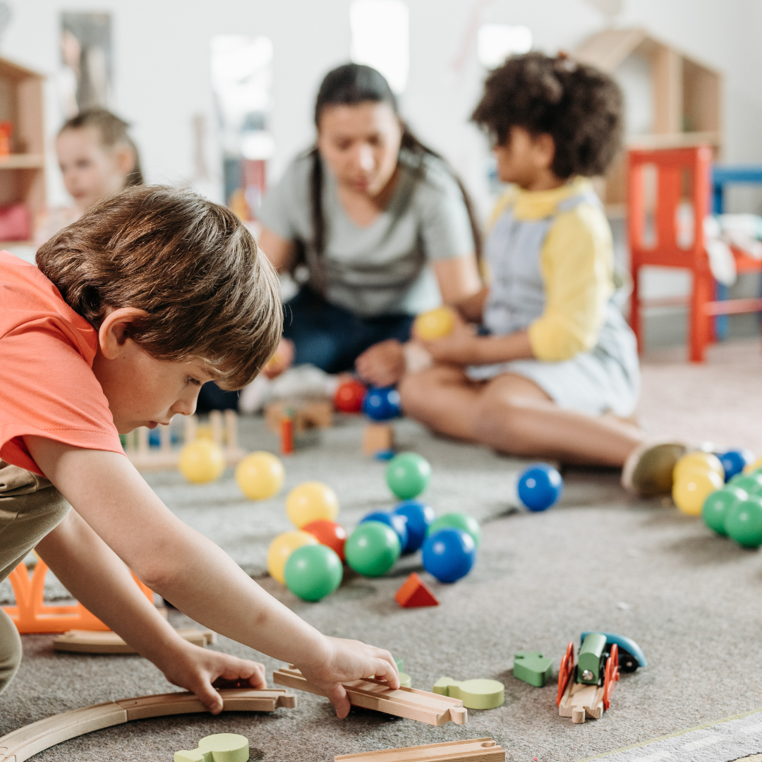 children playing on the rug with toys
