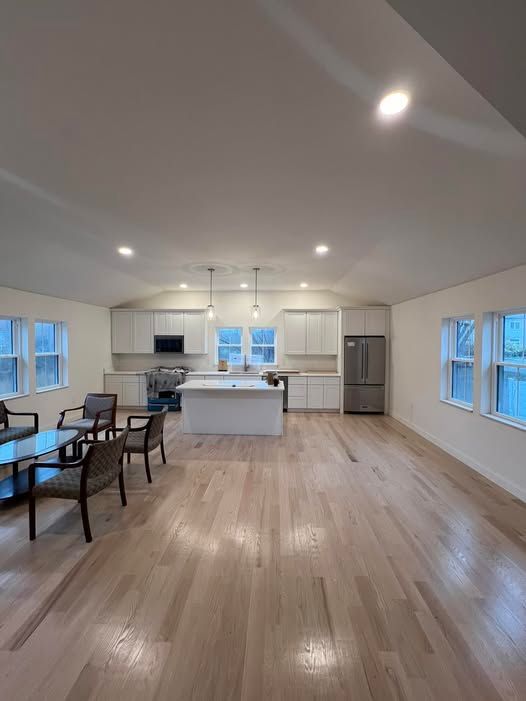 Modern kitchen with white upper cabinets, stainless steel sink, and under-cabinet lighting.
