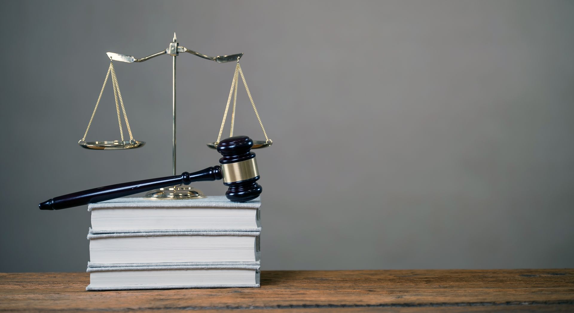 A judge 's gavel is sitting on top of a stack of books.