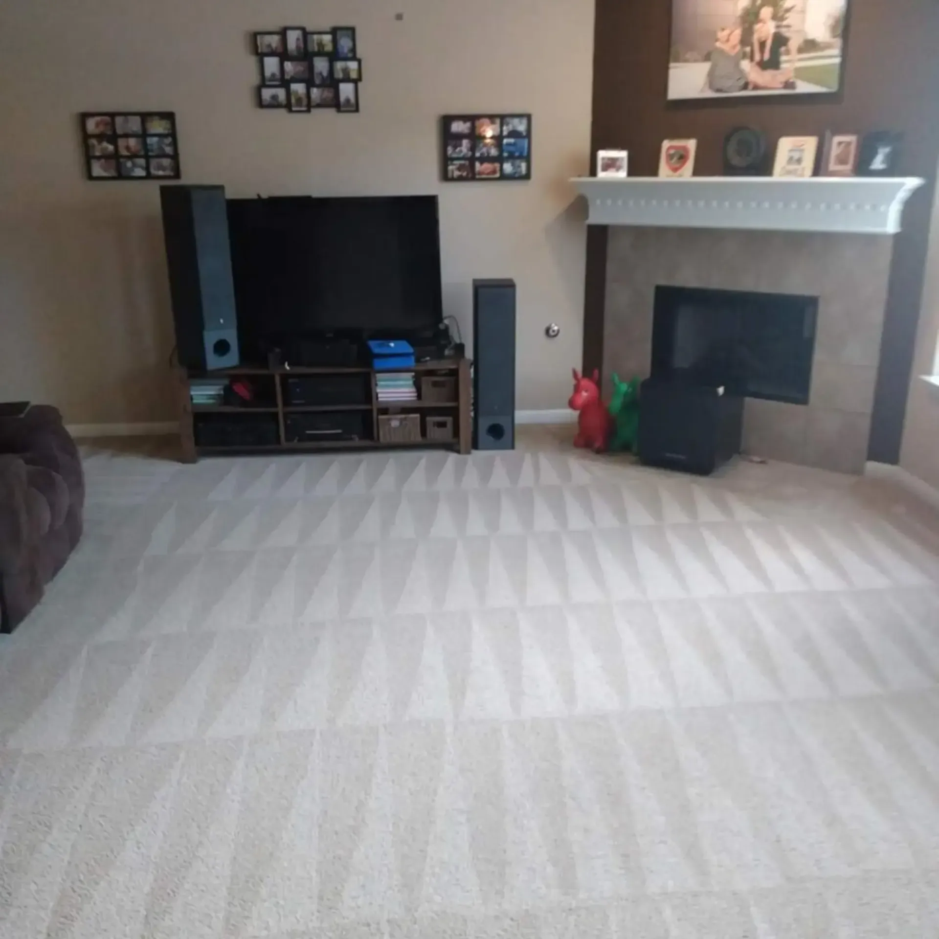 MB Carpet Cleaning- A living room with a fireplace and a flat screen tv
