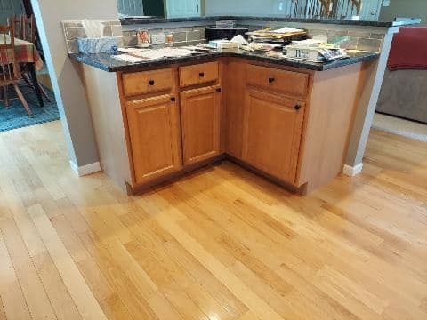A kitchen with wooden cabinets and a granite counter top.