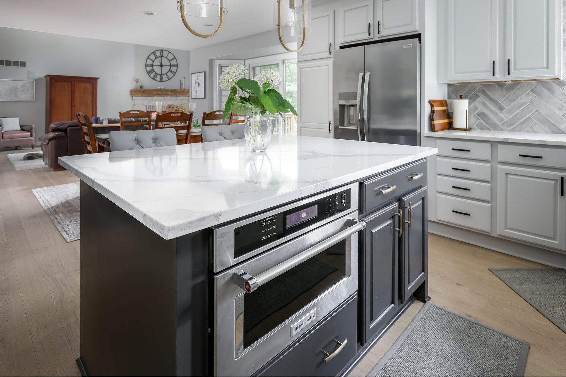 A kitchen with a large island and stainless steel appliances.