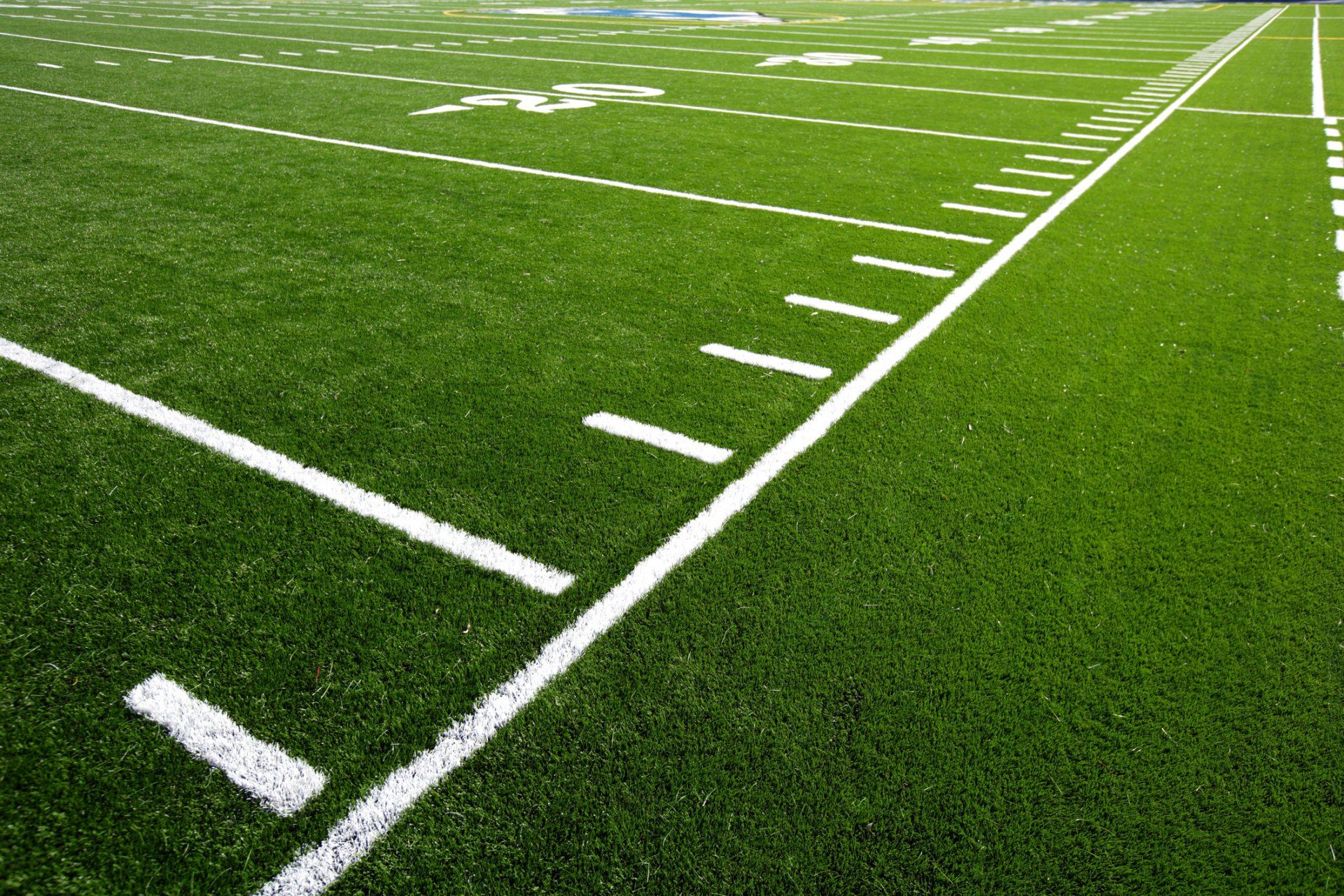 A close up of a football field with white lines on it.