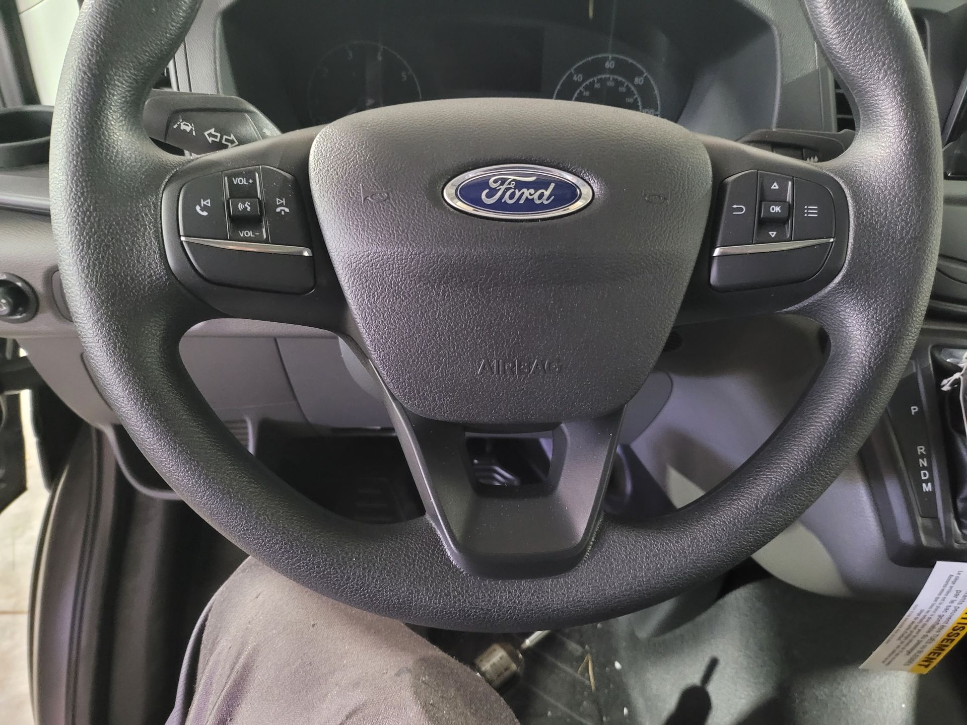 A close up of a ford steering wheel in a car
