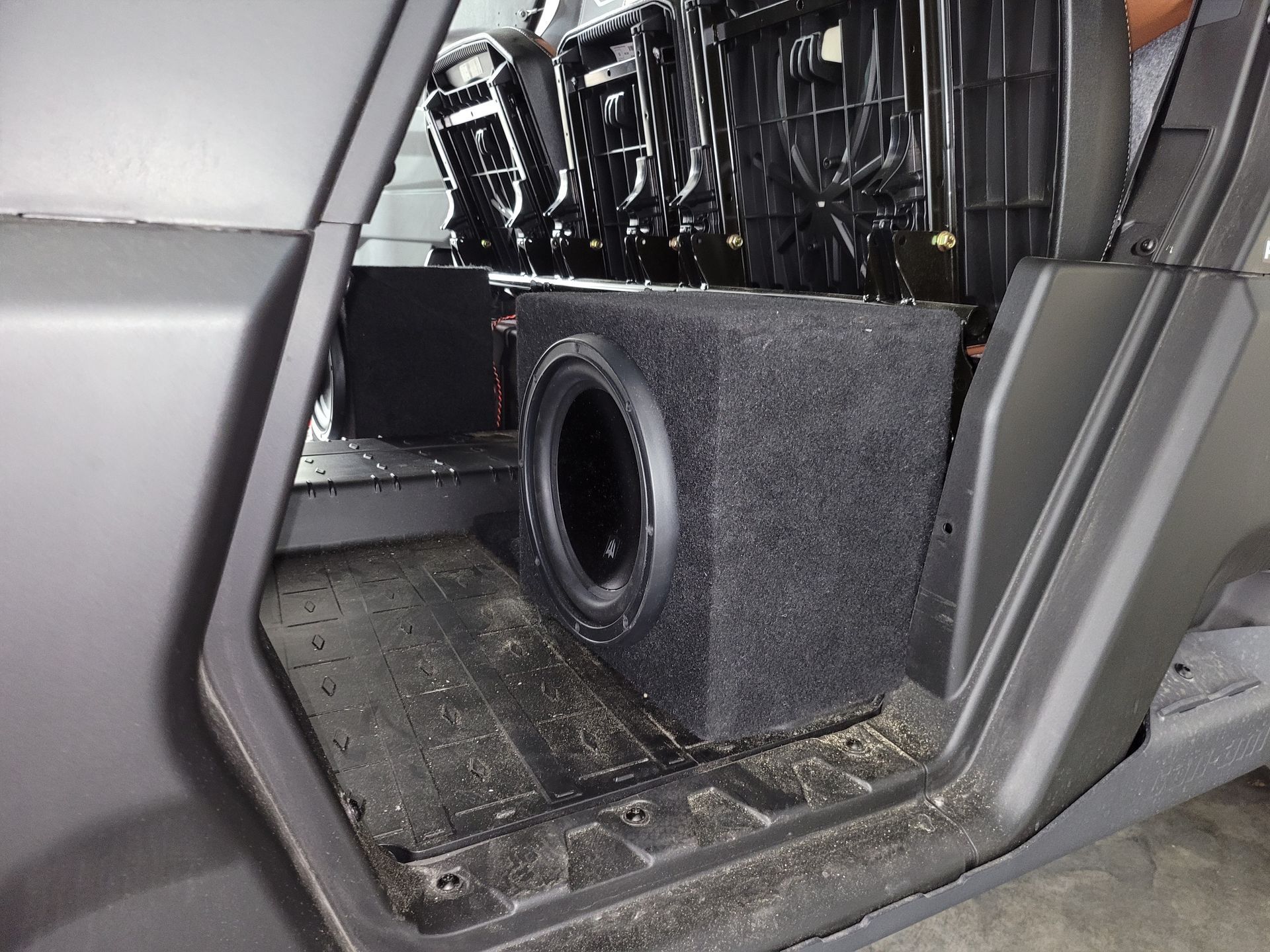 A subwoofer is sitting in the back of a car