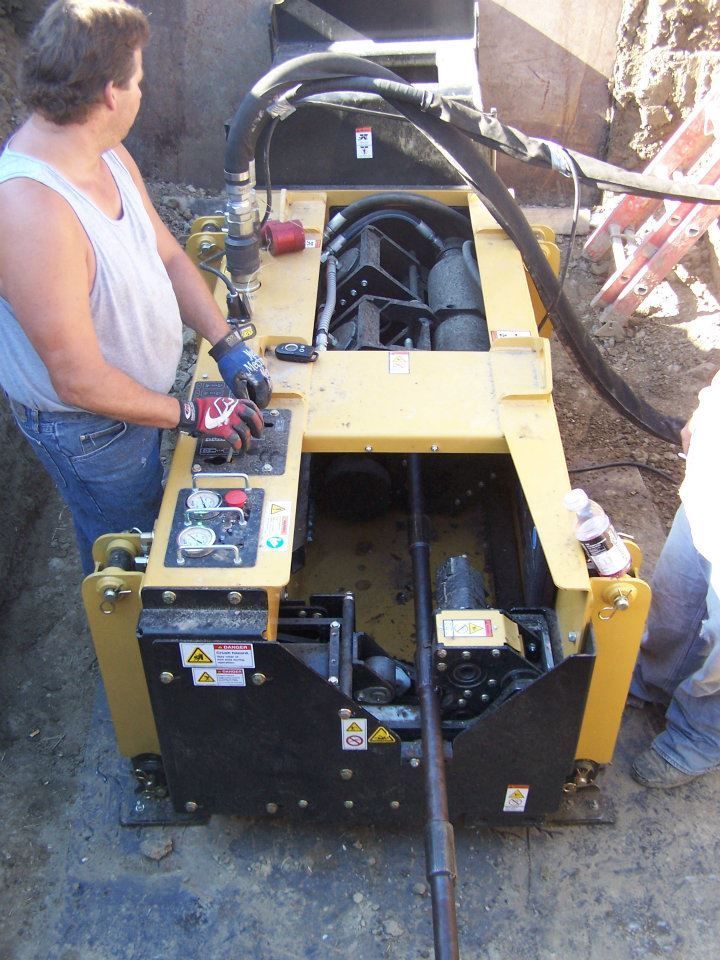White Elite Plumbing van parked outdoors with logo.