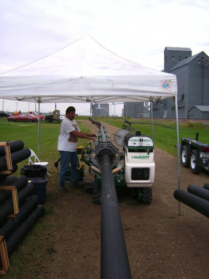 White Elite Plumbing van parked outdoors with logo.