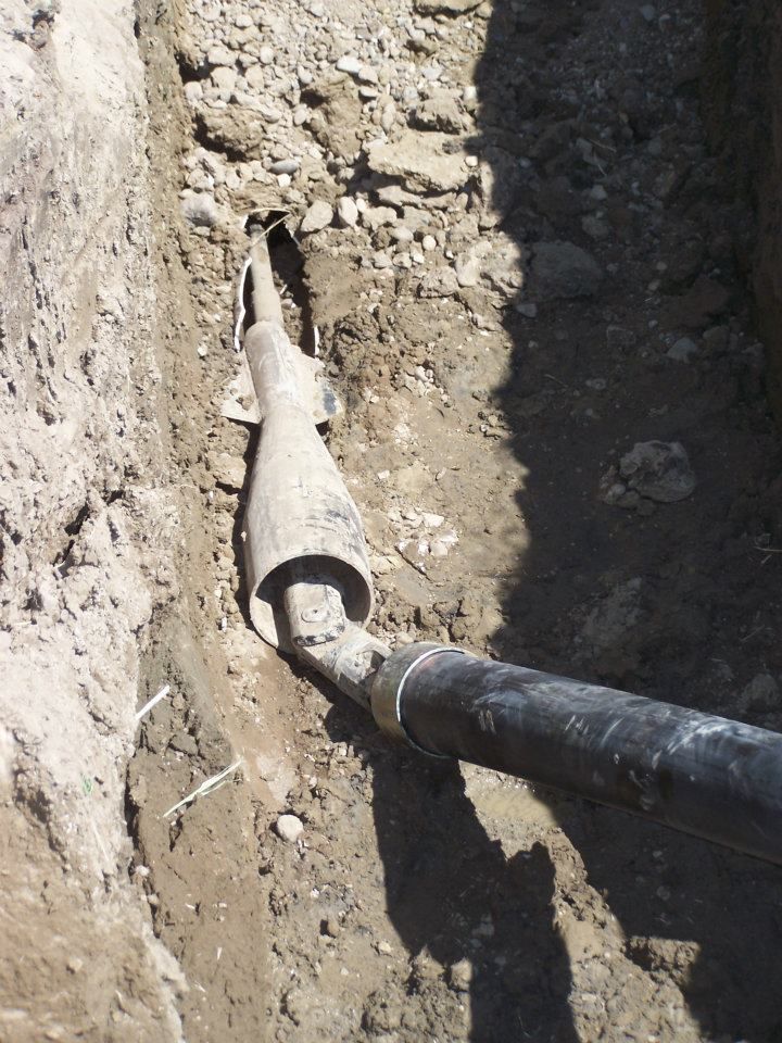 White Elite Plumbing van parked outdoors with logo.