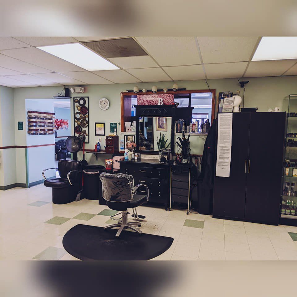 A hair salon with a chair in the middle of the room