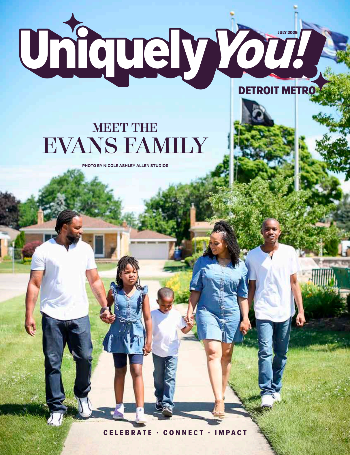 A family is walking down a sidewalk holding hands.