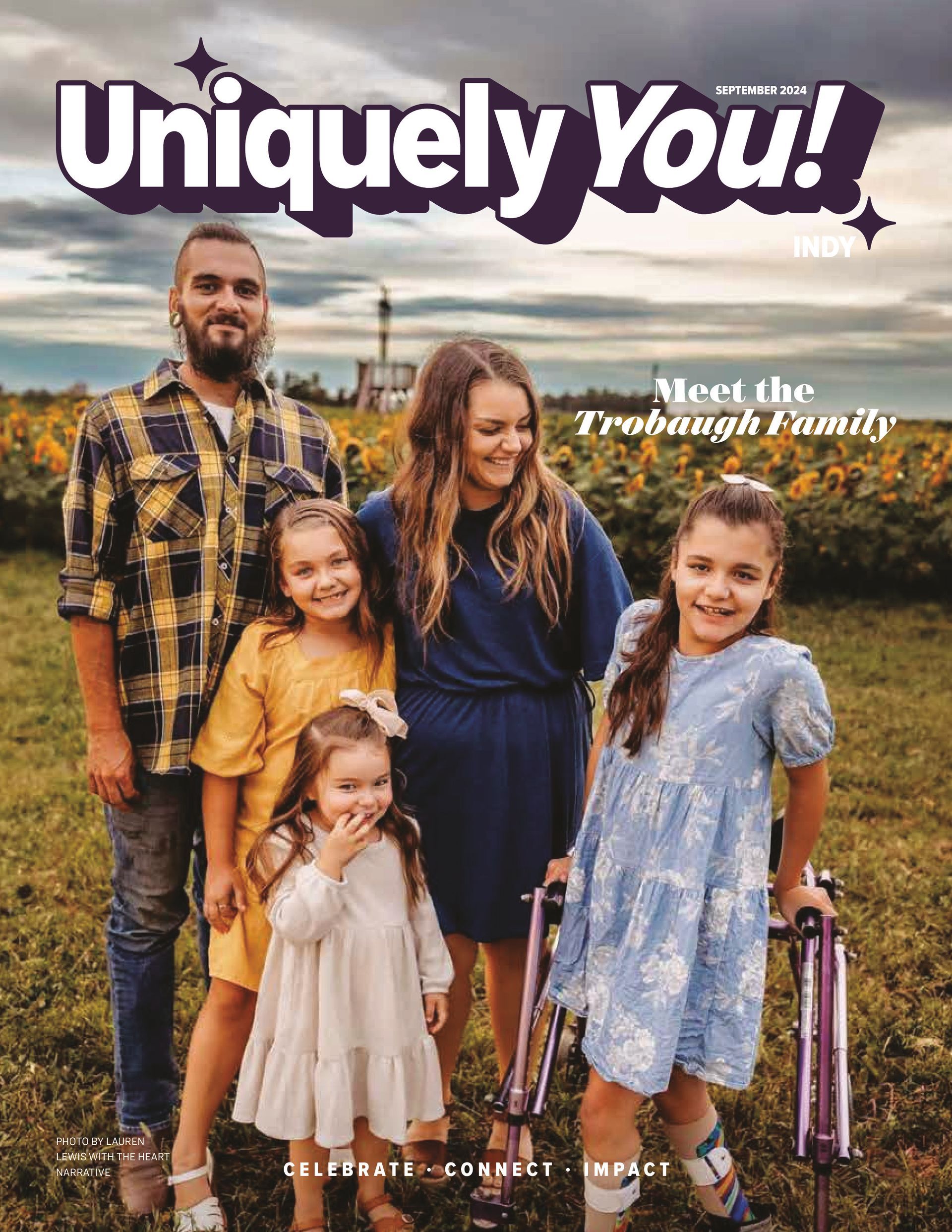 A family is standing in a field on the cover of a magazine.