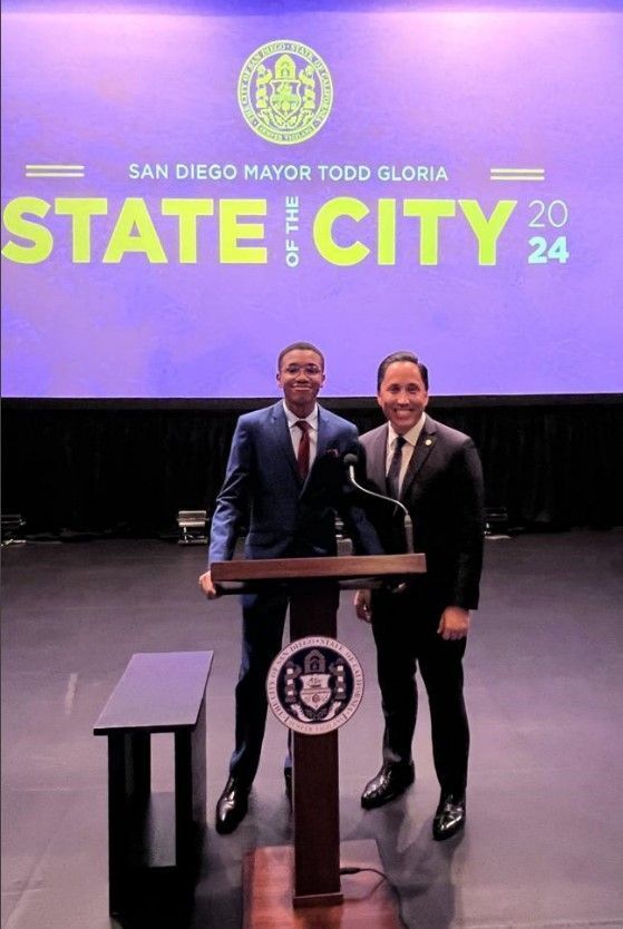 Two men standing in front of a podium that says state city