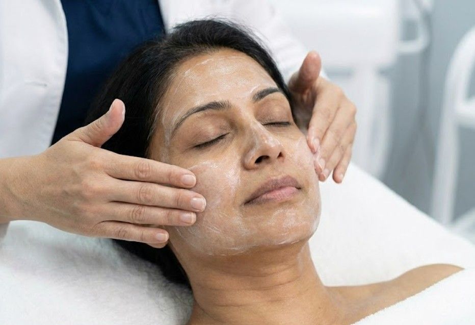 A Skinutrition client massaging a post-peel cream into a client's skin.