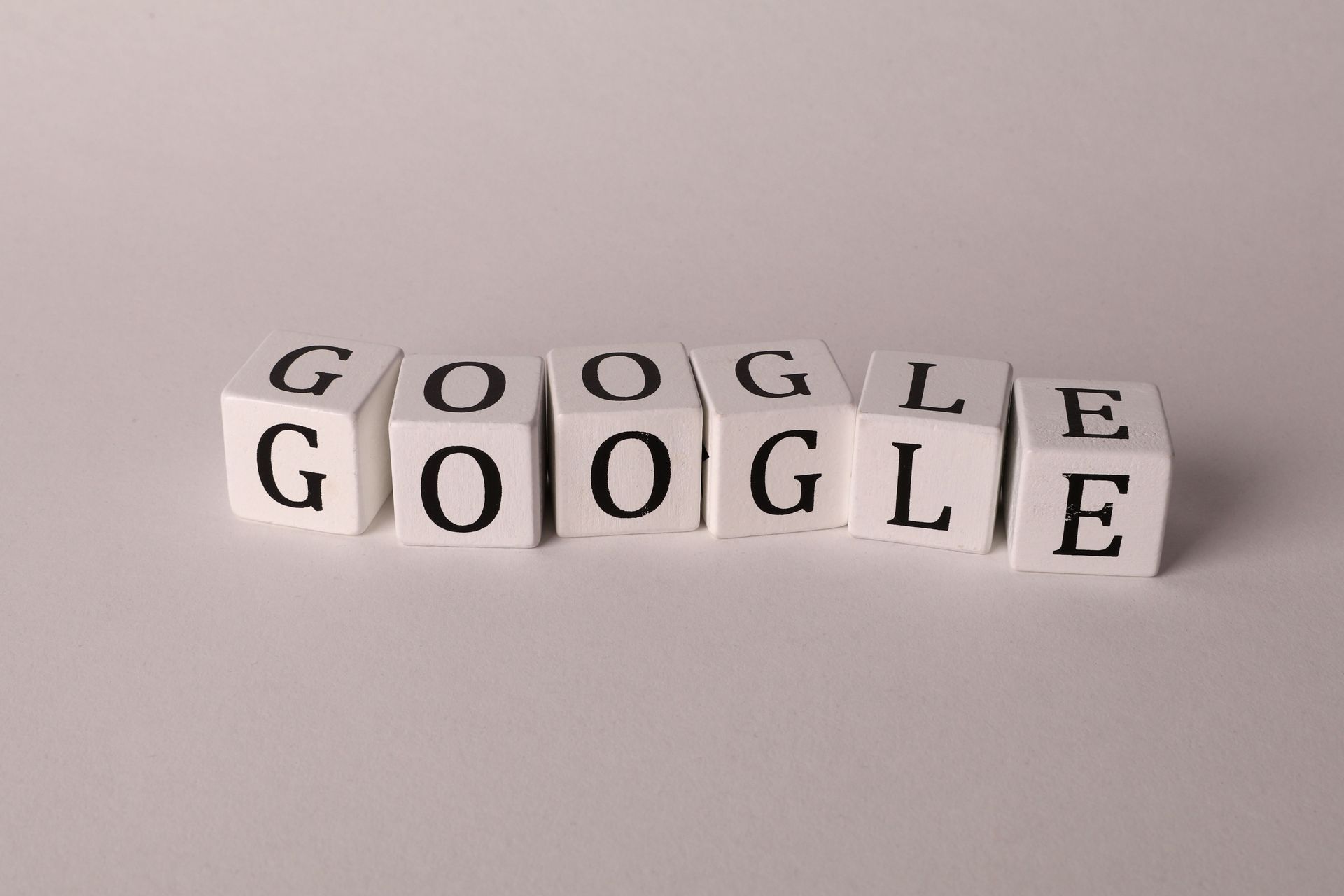 White blocks spelling “Google” on a light gray surface