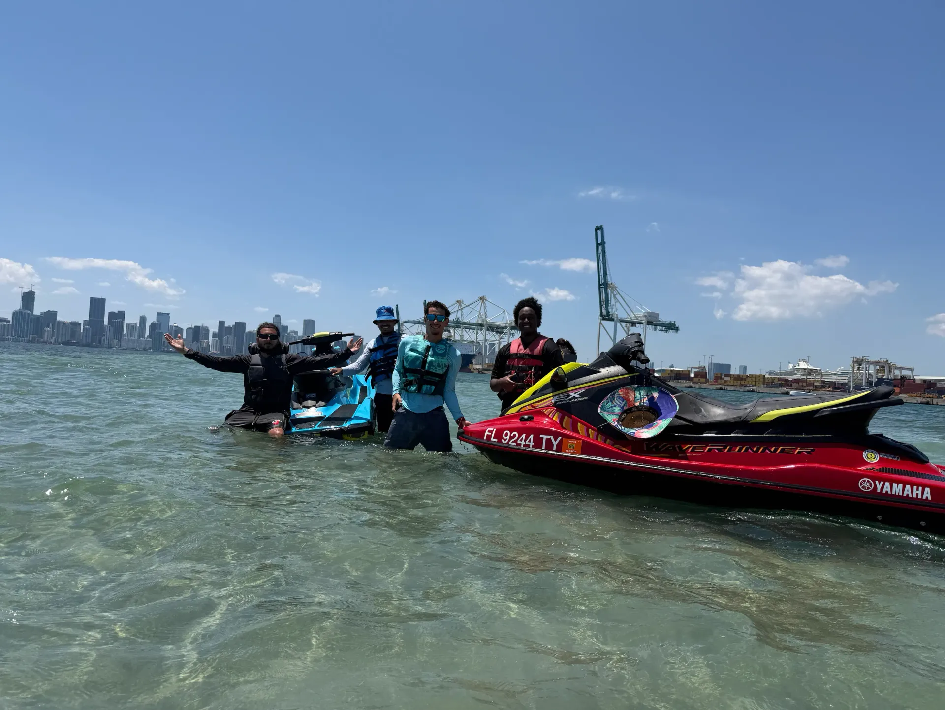Guests enjoying a guided jet ski tour across Biscayne Bay with views of the Miami skyline