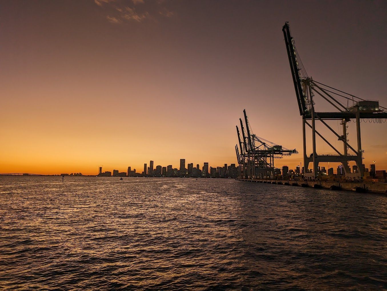 The port of Miami and the Miami Skyline seen on the background with sunset, on the Sightseeing sunset boat cruise