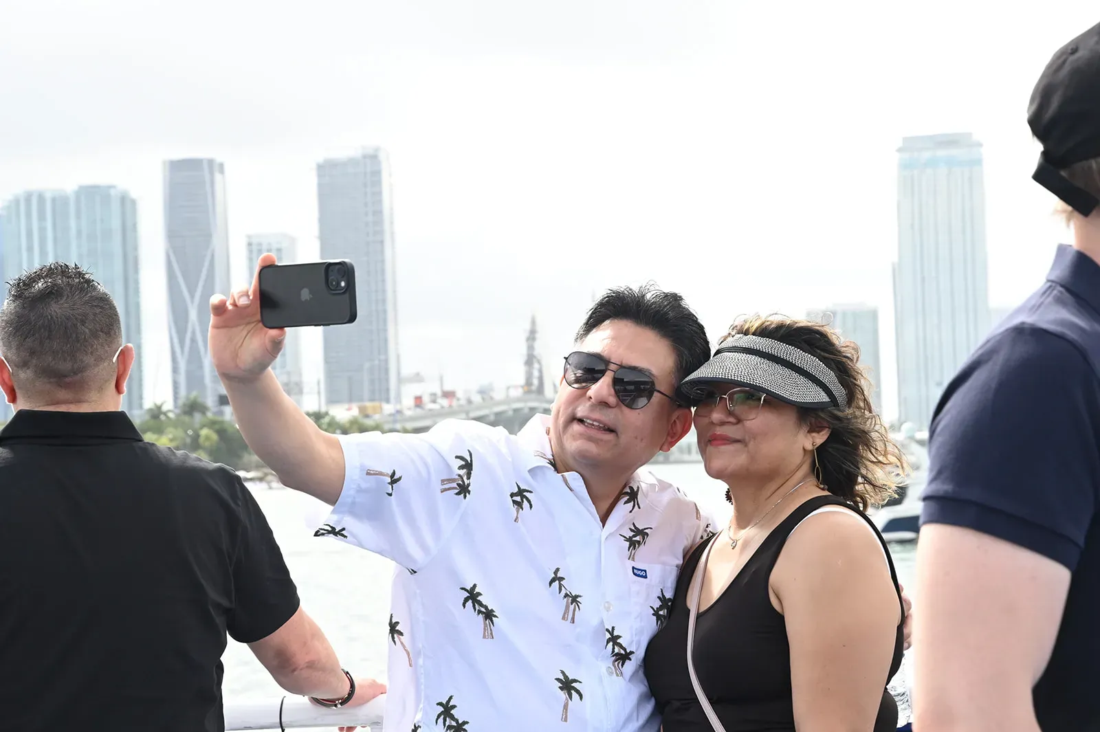 Guests capturing photos during Miami Boat Tours with the city skyline in the background