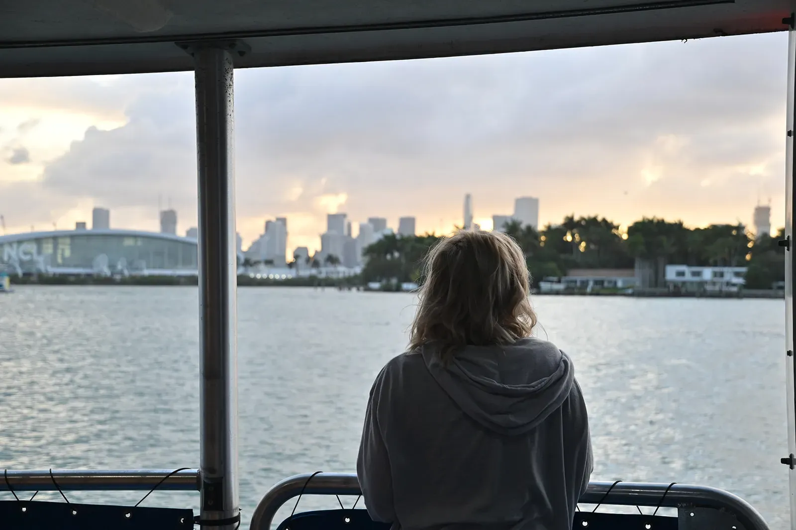 guest enjoying a peaceful Boat tour Miami experience during sunset with skyline views