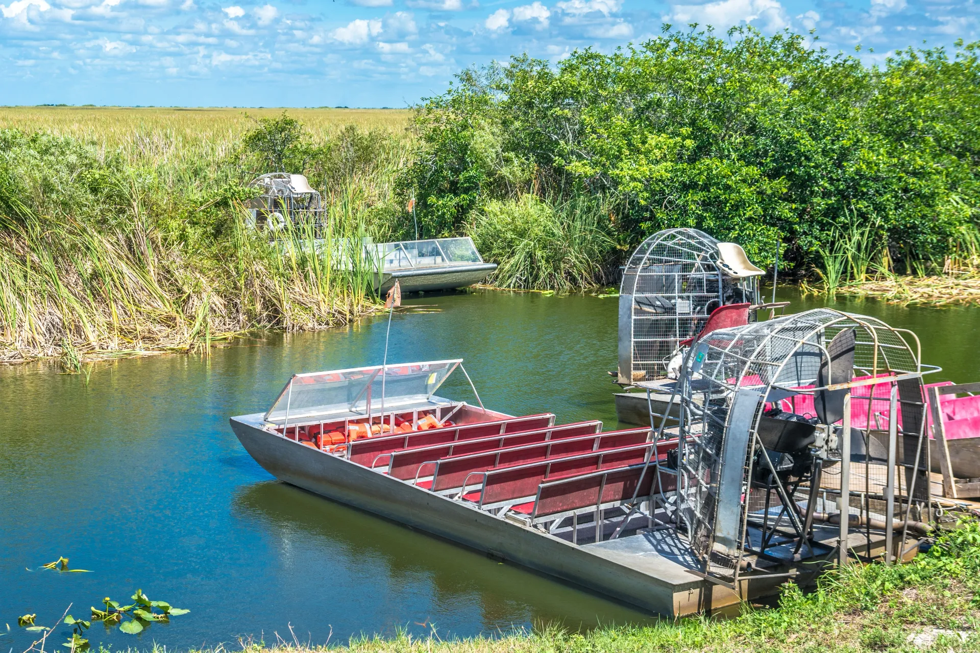 Everglades airboats preparing for a South Florida Everglades excursion through wetlands and sawgrass marshes