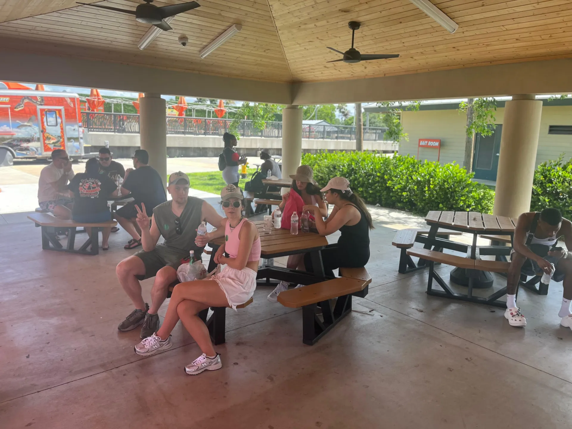 Guests relaxing in the shaded pavilion area at Holiday Park before their Everglades airboat adventure