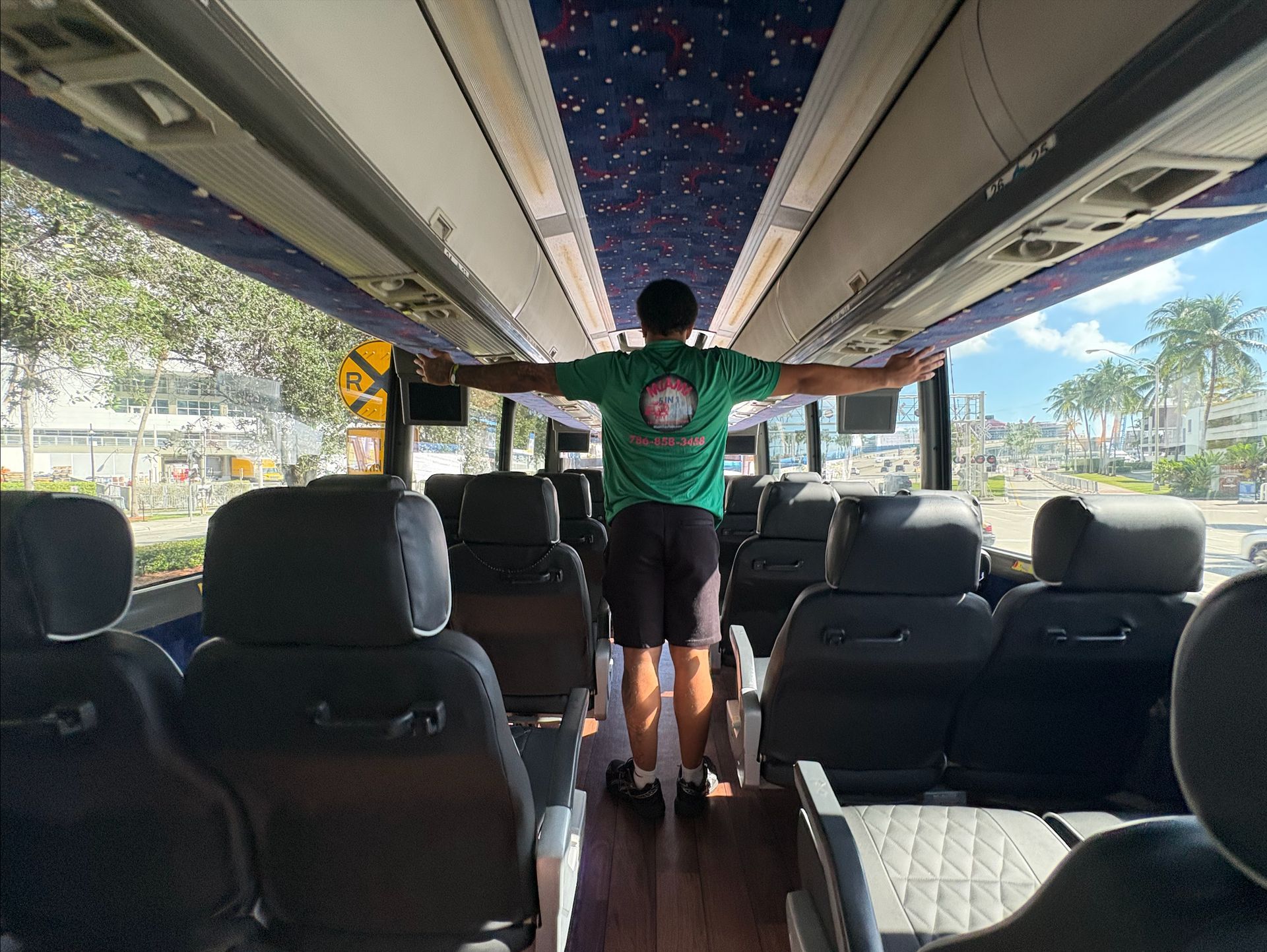 Key West Bus Tours leather seats and Key West employe with his hands spread